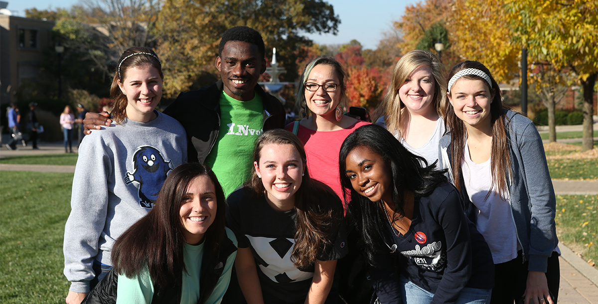A group of Xavier students smiling on campus