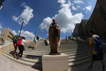 Bronze statue of Saint Ignatius which is located on the Ignatian steps within the Xavier University campus