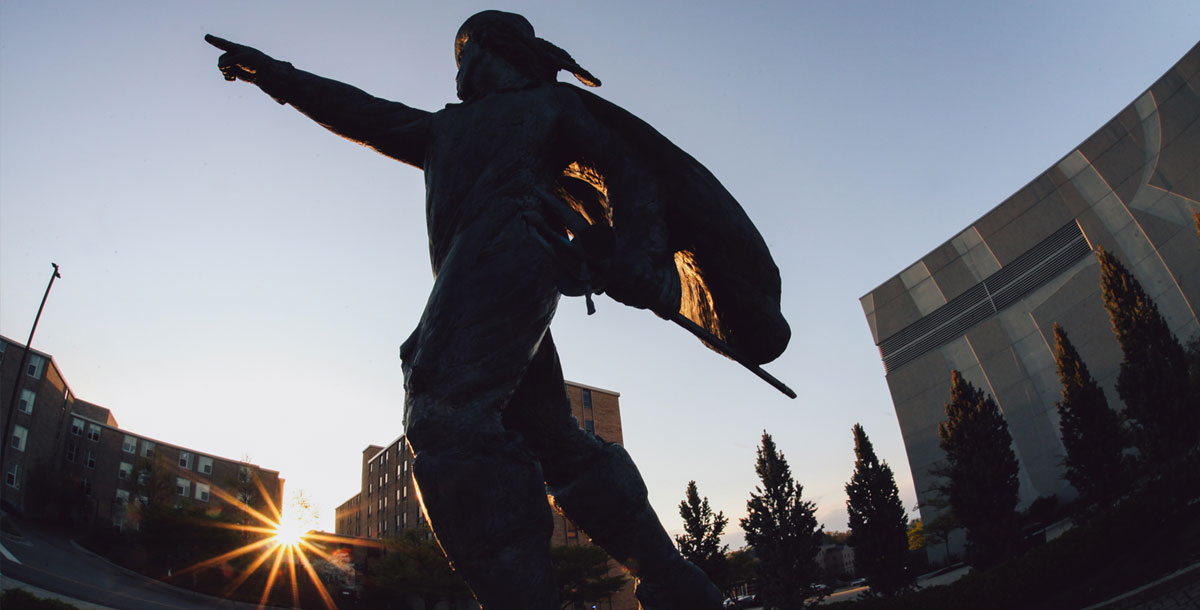 The D'Artagnan Statue in front of Cintas Center points it's finger toward the sky while the sun sets.