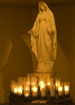 Statue of Mary surrounded by candles