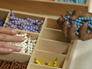 Students in the Montessori program showing a toy to a child