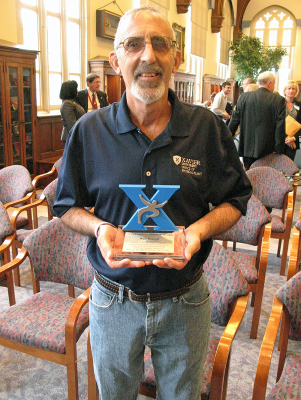 Walt Bonvell holding award