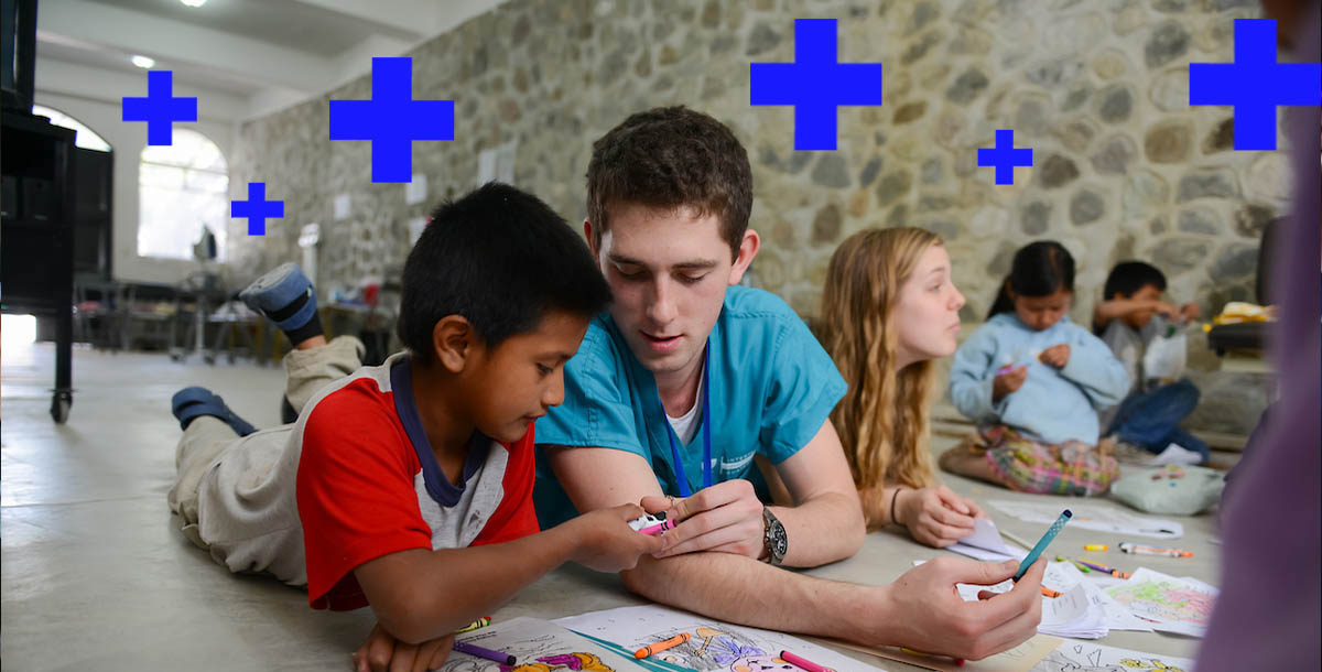 a student coloring with a child 