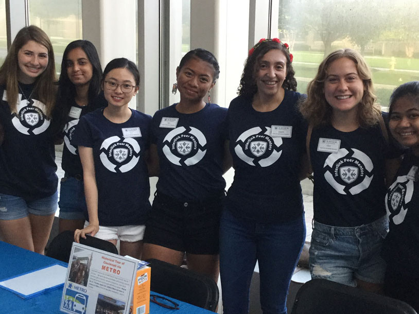 A group of seven students smiling at the camera together. 