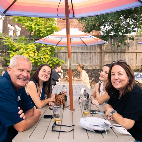 Family Sitting at Table enjoying outside