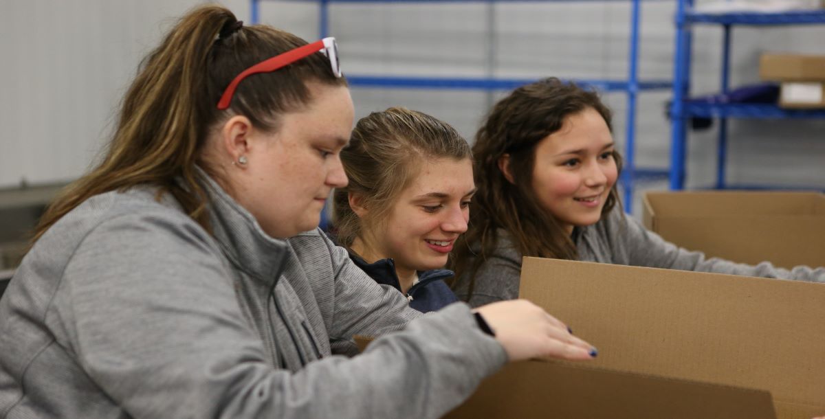 Women filling boxes with food 