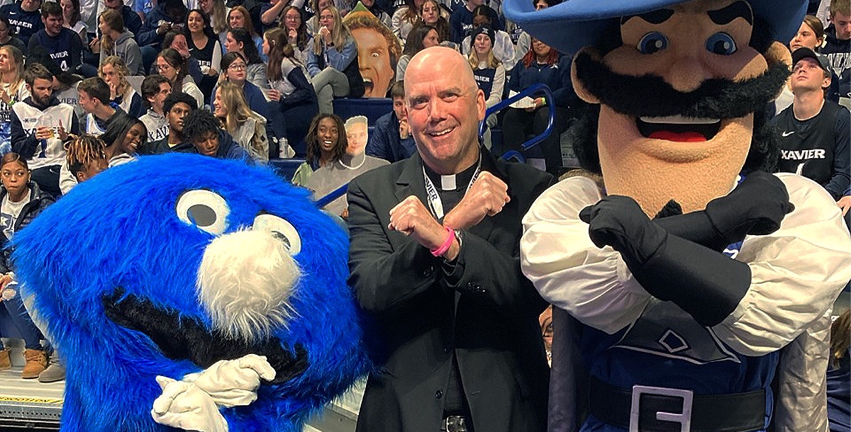 The Blue Blob, Xavier's Athletic Chaplain and D'Artagnan create an X with their arms