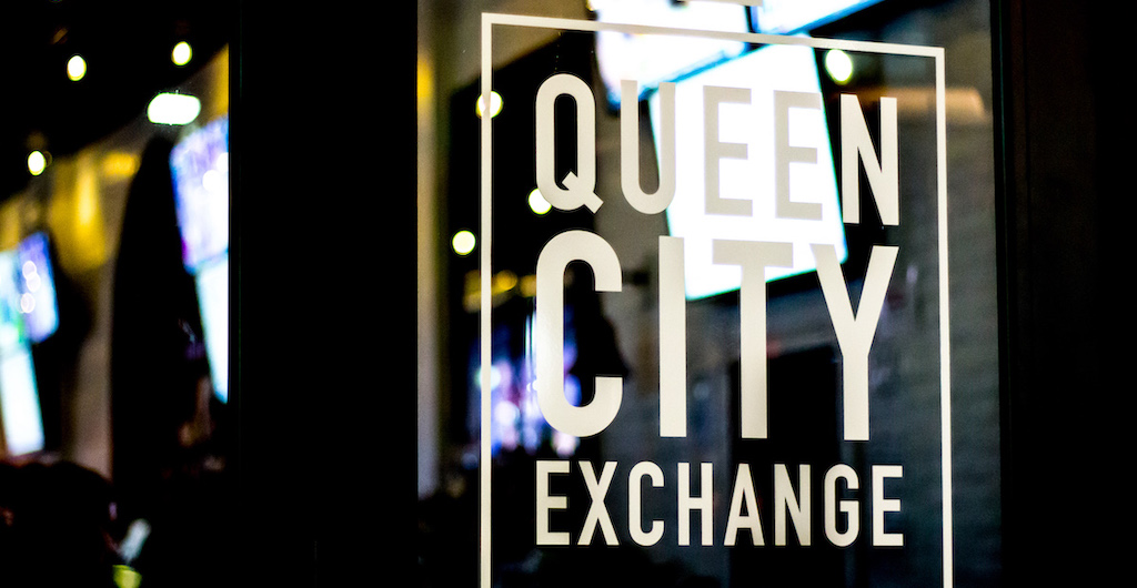 Queen City Exchange text on glass. 