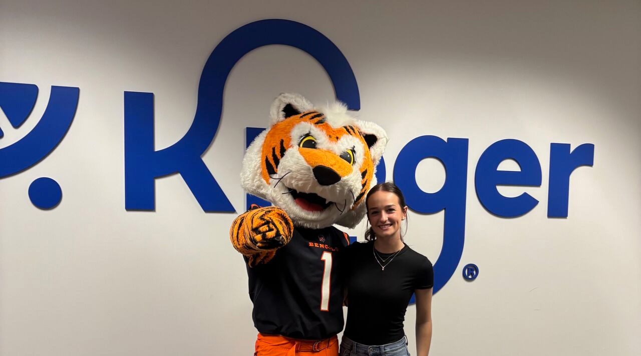 Xavier Graphic Design student posed with tiger mascot
