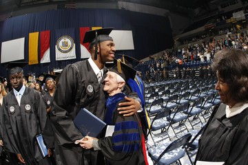 Student hugs faculty at graduation