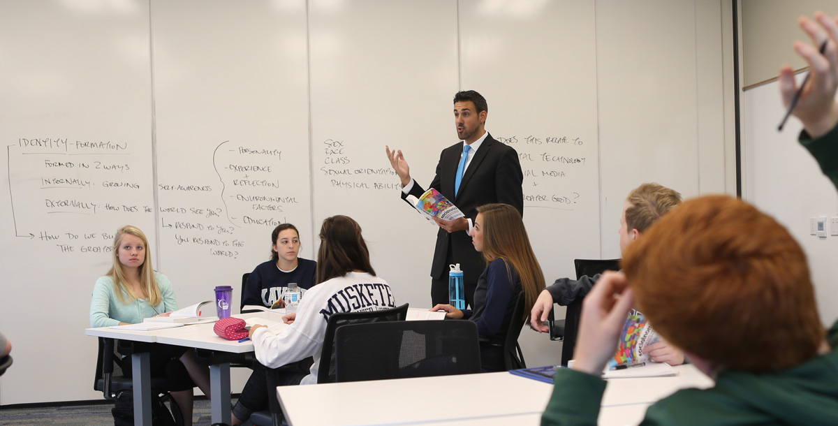 Theology professor teaching a group of Xavier students