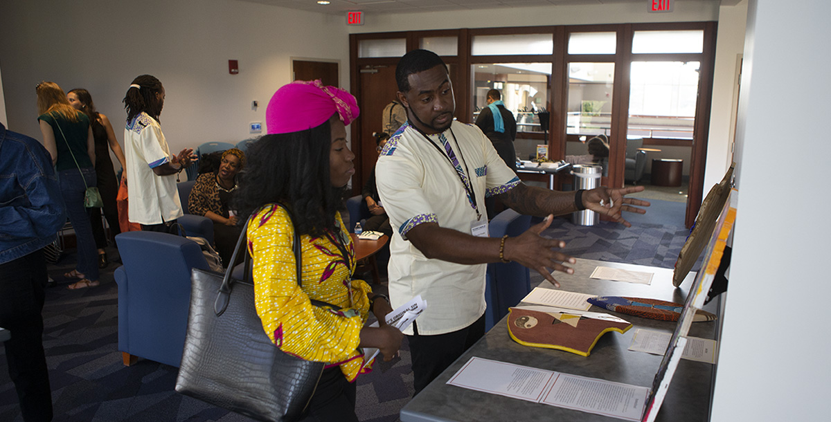 Two students looking at a poster detailing one of the First-Year-Seminar courses