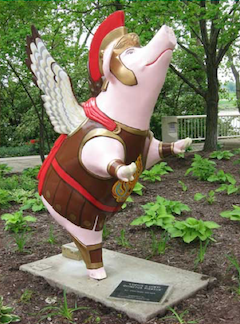 A statue of a pig with wings. The pig is wearing a traditional roman warrior costume.