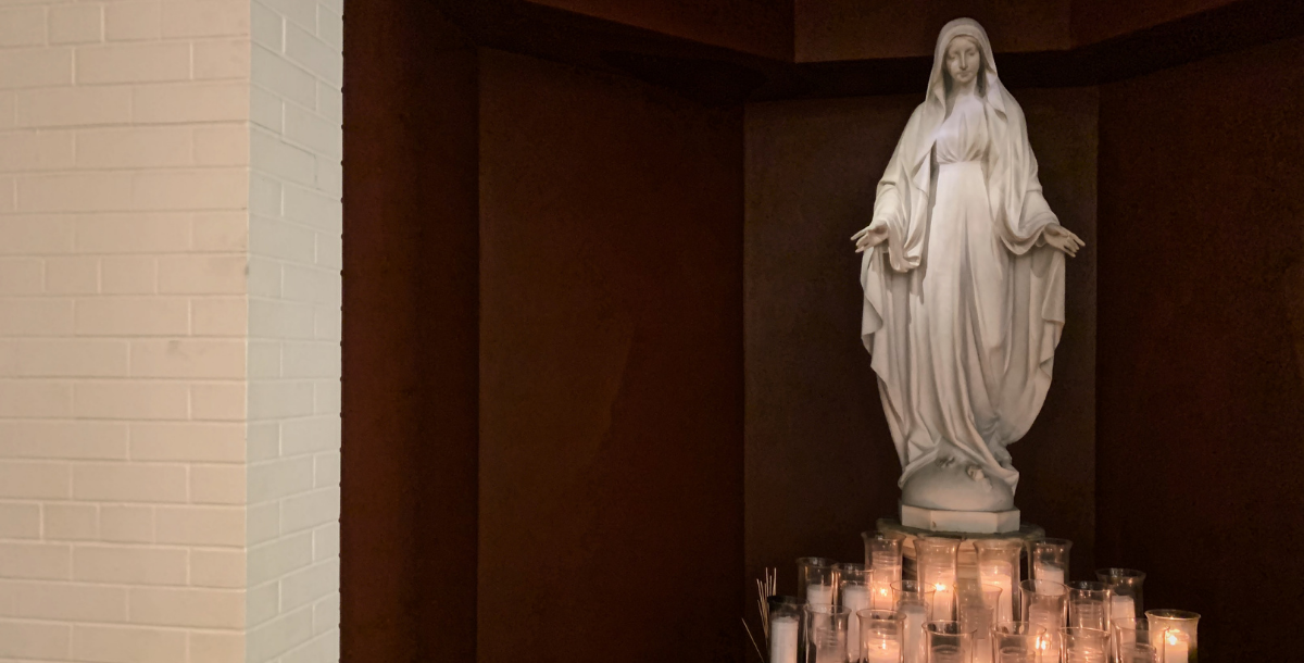 Statue of Mary in Bellarmine Chapel with candles lit