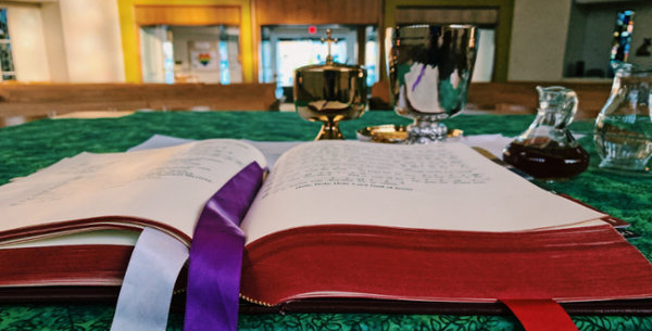 Altar set for daily mass with lectionary open.