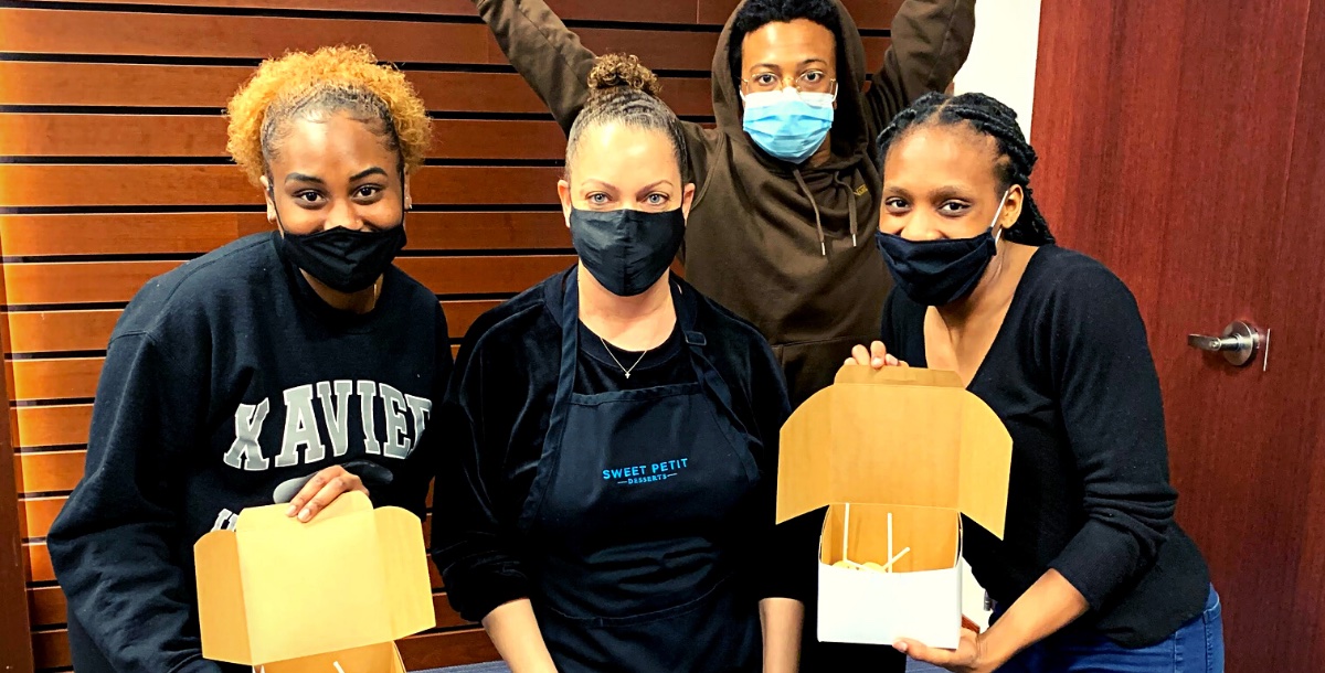 Three students with baker in an apron