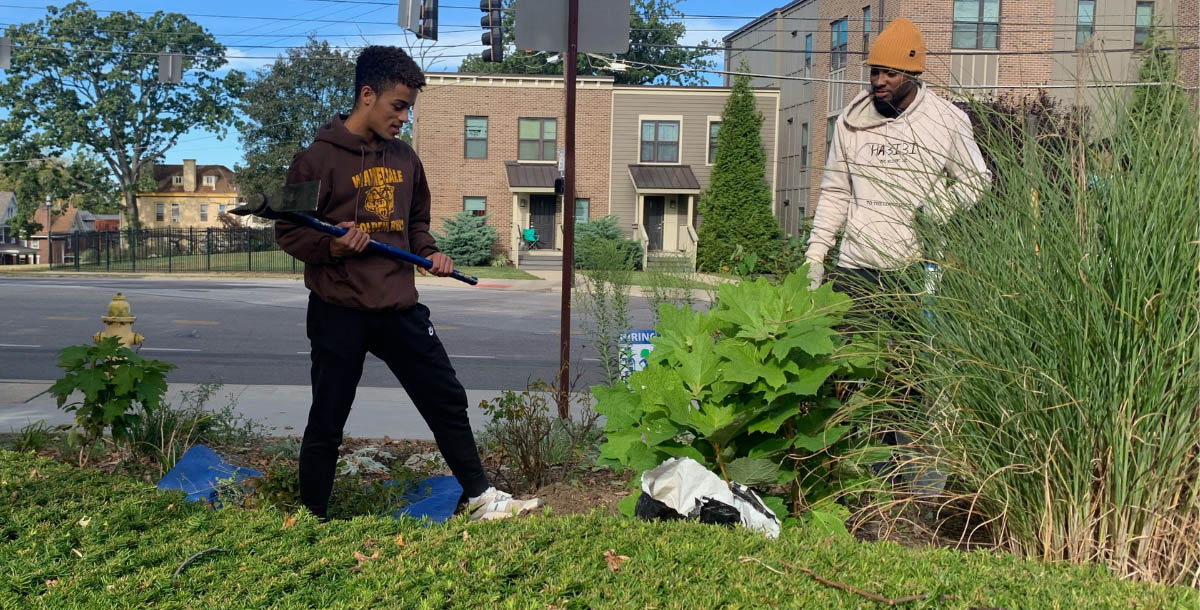 Two people engaging in landscape clean up on Community Action Day