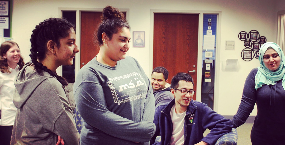 Four students talking after the weekly Islamic prayer group