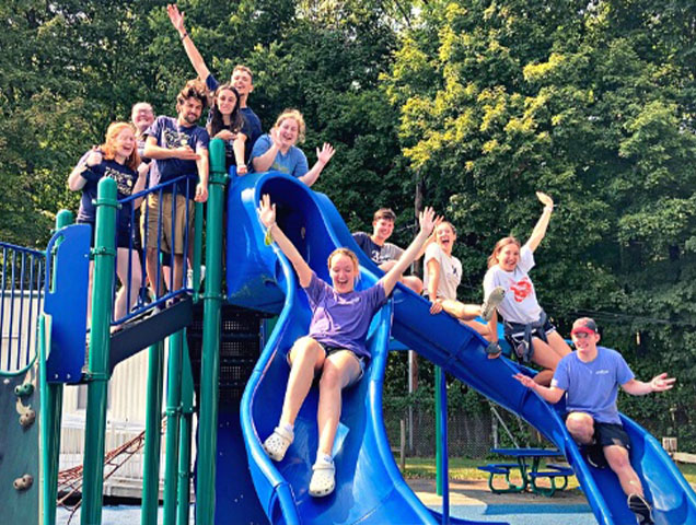 A group of ten students hanging out on a playground