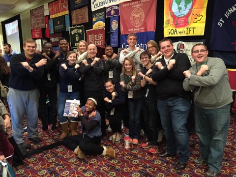 Group Photo of Students in front of Banners and Posters