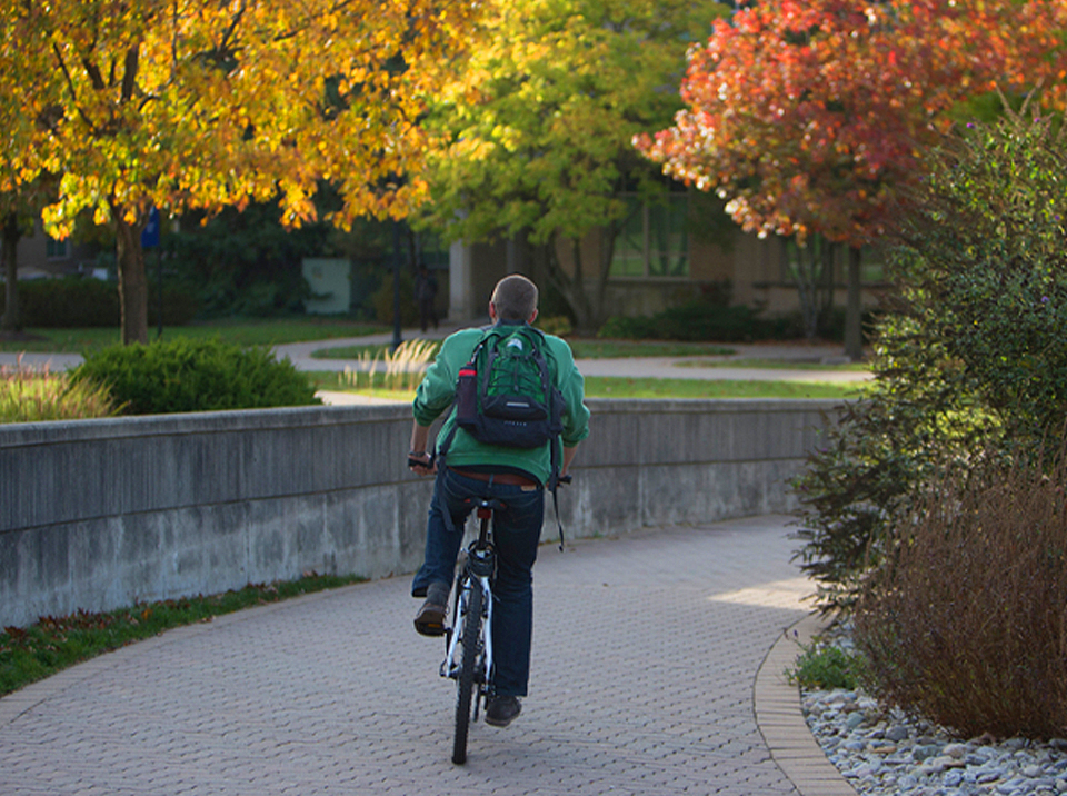 Student biking on campus