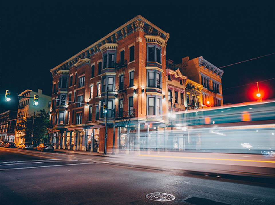 Long exposure photograph of a car driving in Cincinnati at night