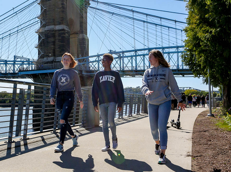 Three Xavier students walking in downtown Cincinnati
