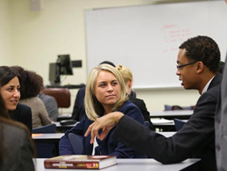 Student earning their masters in clinical counseling learning in a classroom