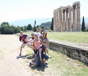Photo of Anna Wiley with a Group of Peers next to the Temple of Olympia in Greece