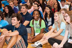 students sitting together on a gymnasium floor