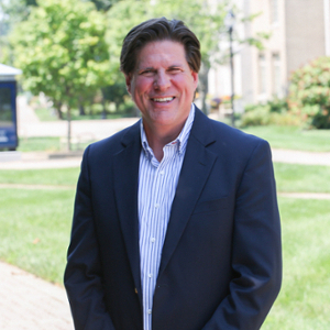 A professional portrait of Russell Lacey outdoors on Xavier's campus.