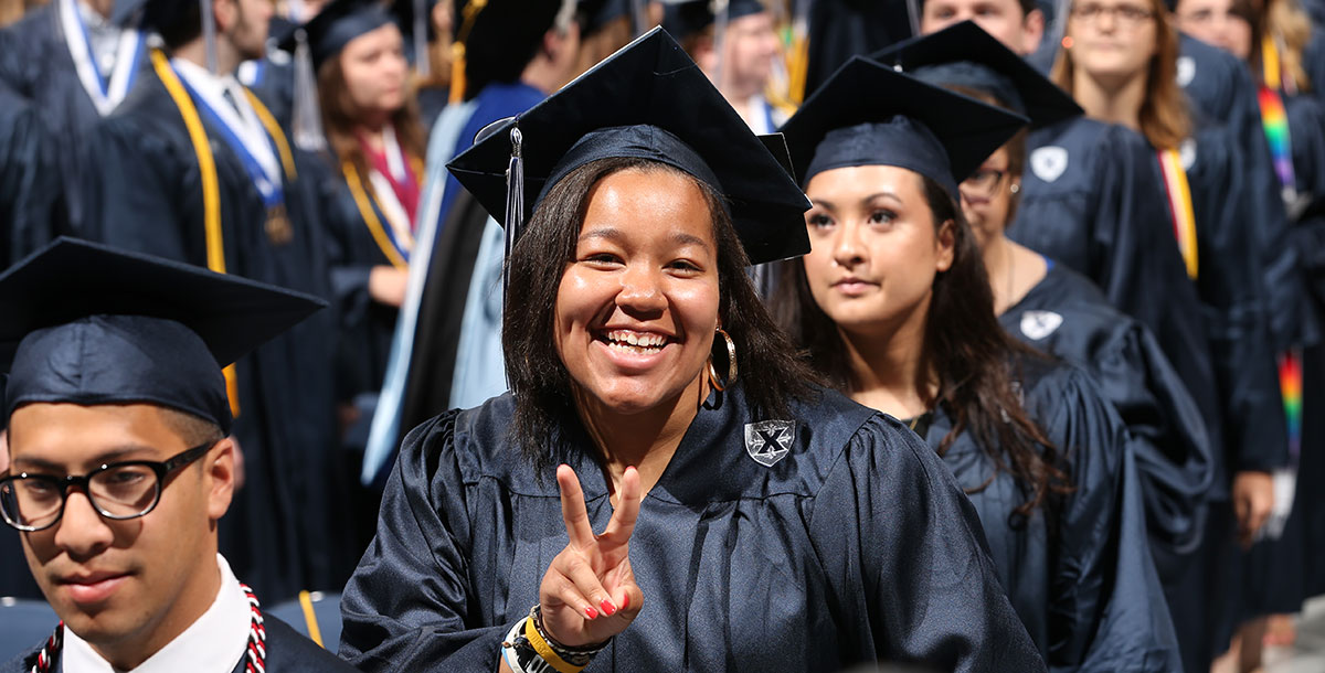 Education student wearing a cap and gown during a commencement ceremony