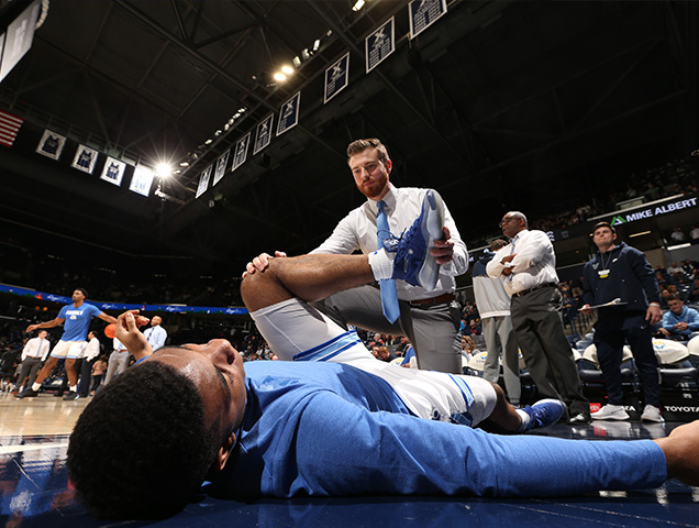 Exercise science majors helping a athlete before a game 