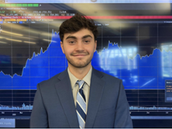 Photo of Elliot Bandrowski in front of a stock graph