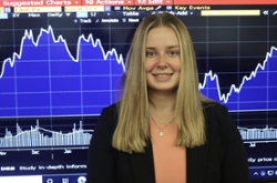 Photo of Nicole Folan in front of a stock graph