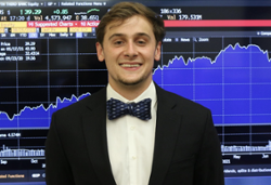 Photo of John Fritz in front of a stock graph