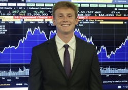 Photo of Avery St. Pierre in front of a stock graph