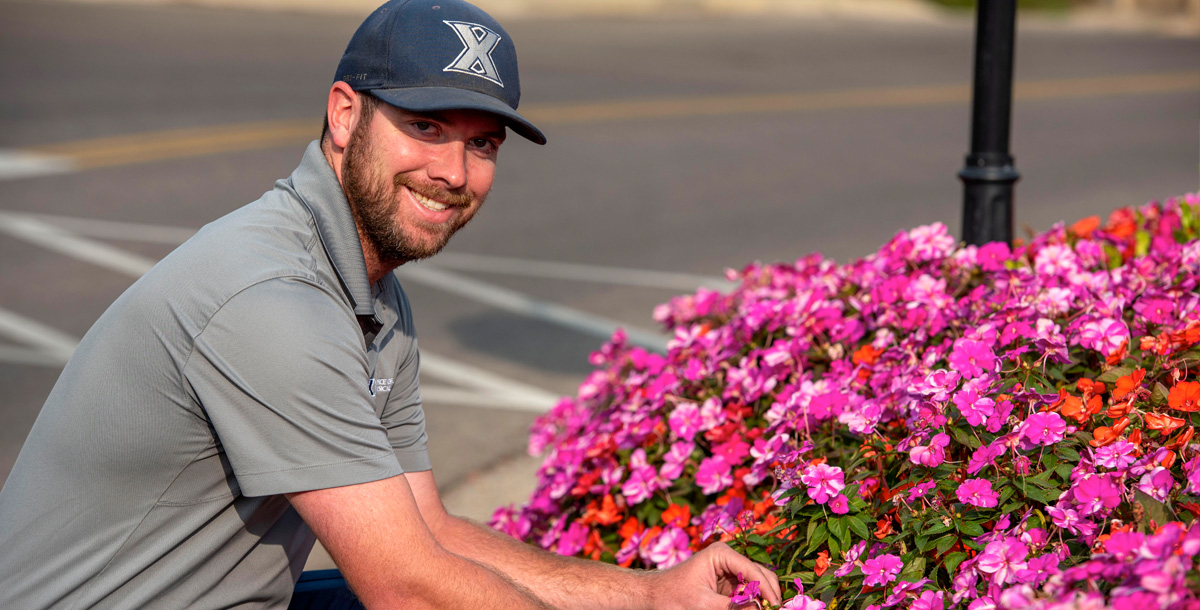 Employee maintaining the grounds on campus.