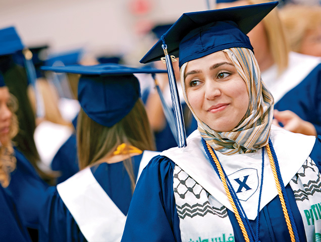 Student wearing a cap and gown during commencement