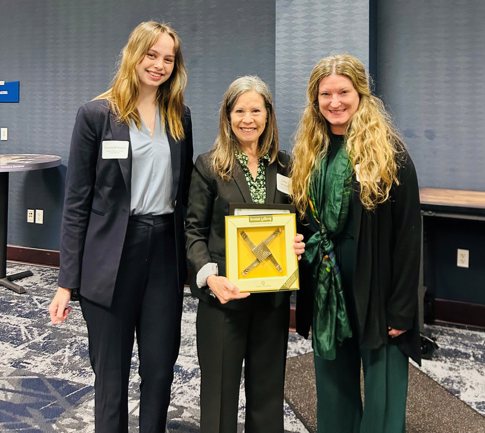 The Brigid Kelly Public Service Award being awarded to Hamilton County Commissioner, Denise Driehaus by Women in Politics President, Emma Schwarz, and advisor Dr. Katie Robiadek