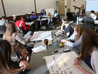 A classroom full of students learning from a professor