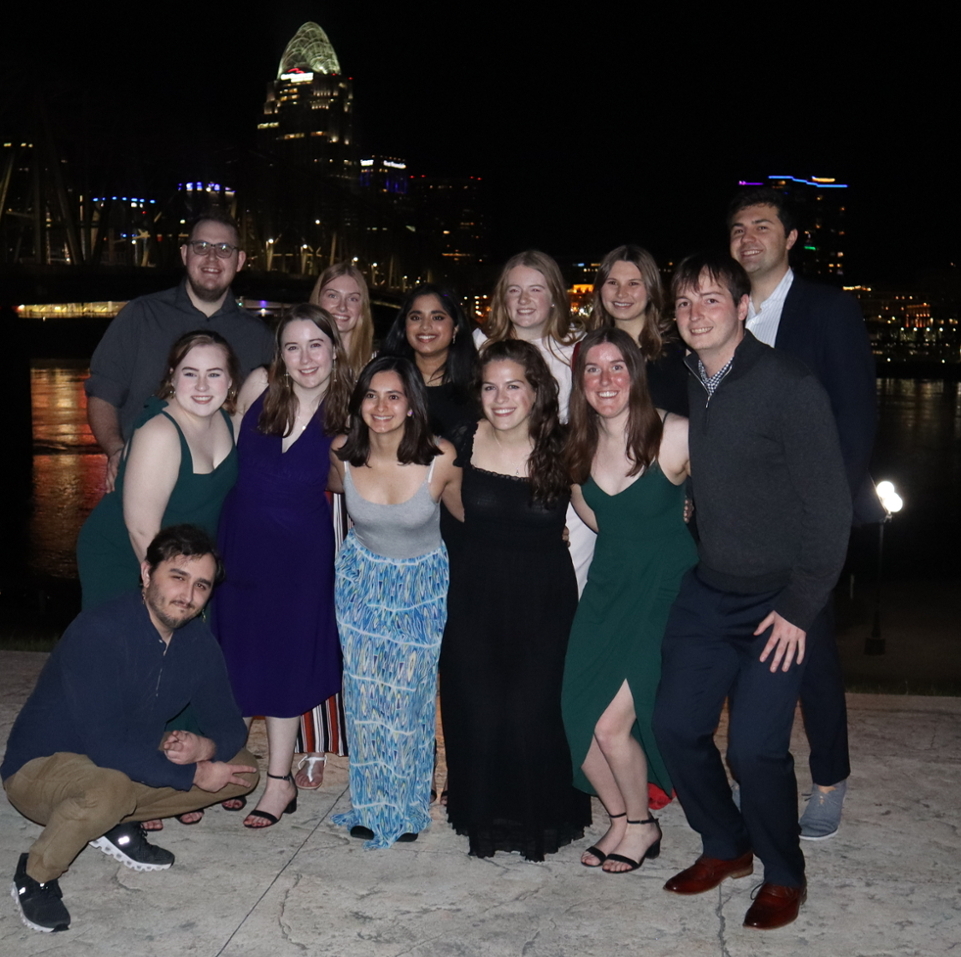 Xavier graduate students in front of the Ohio River at night