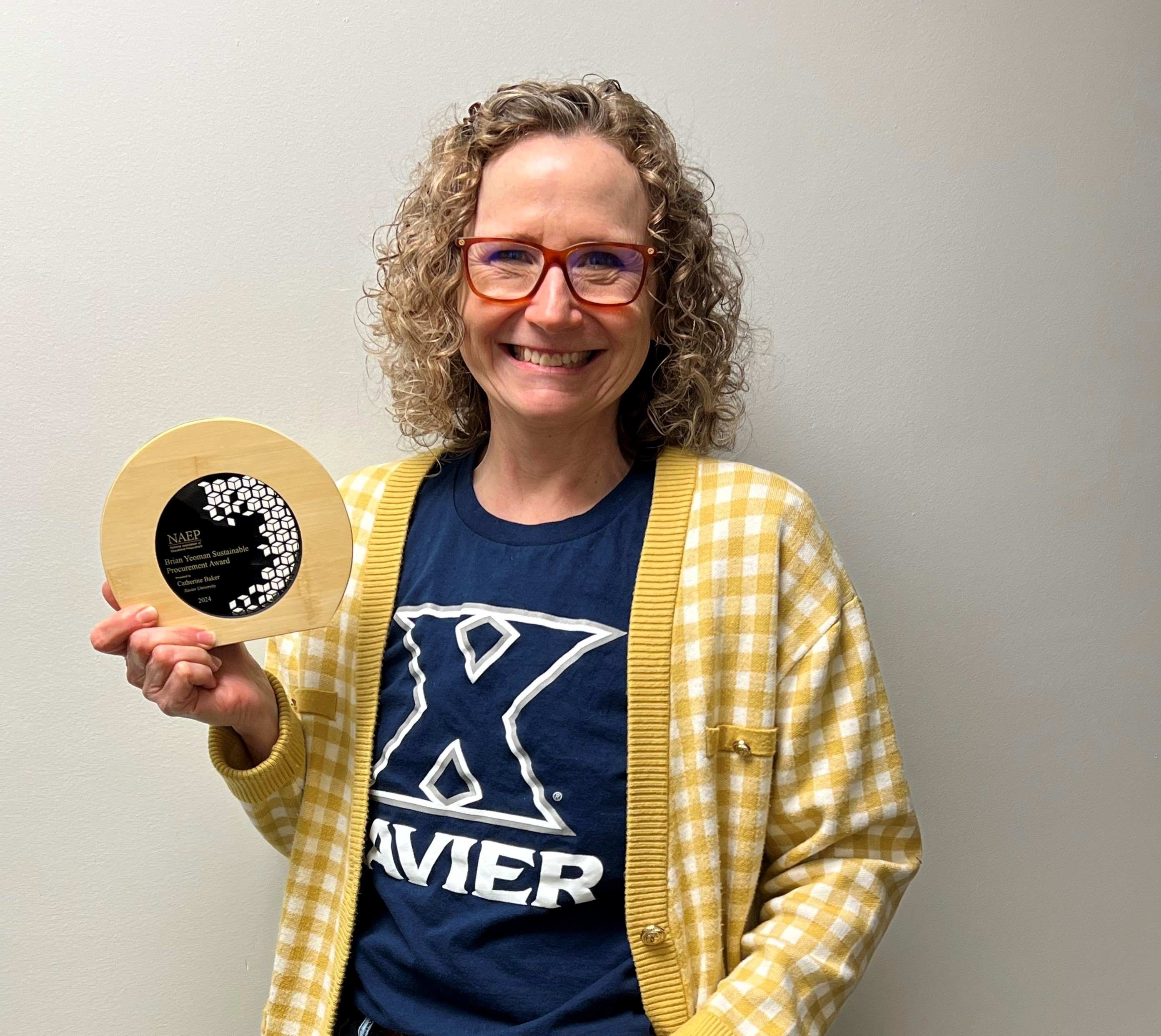 Catherine Baker holding her award