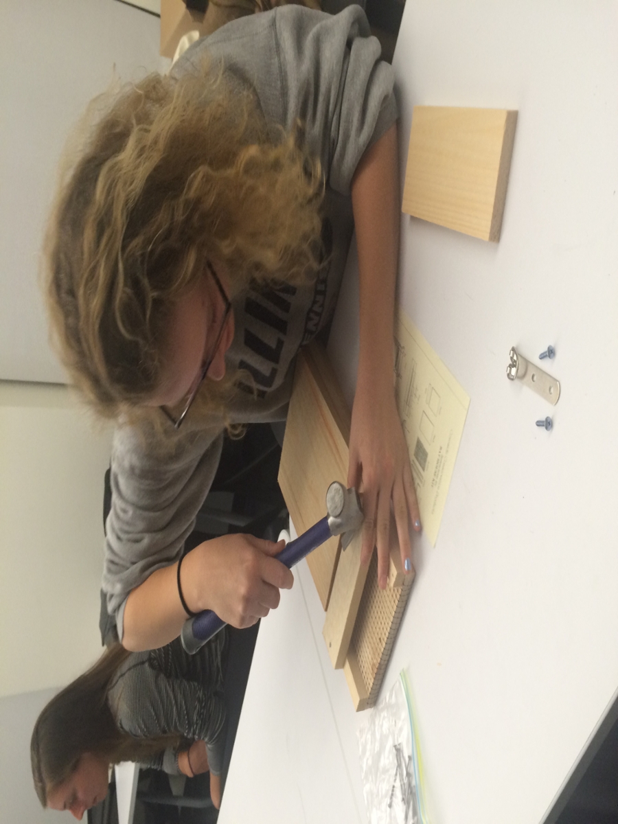 Photo of Student cutting cardboard box