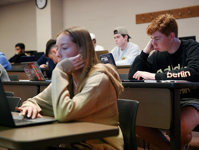 Students sitting at a desk during class
