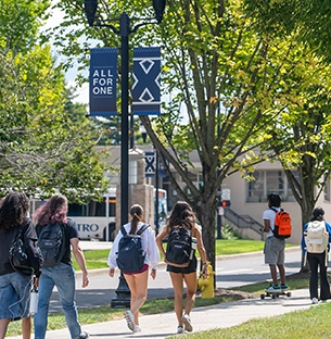 Students walking on a sidewalk on campus