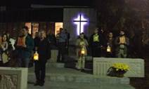 People outside paying respects at the Martyrs of the University Memorial at Xavier University