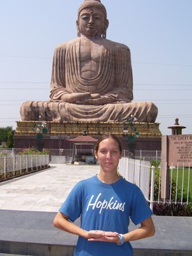 Someone standing near giant Buddhist monument 