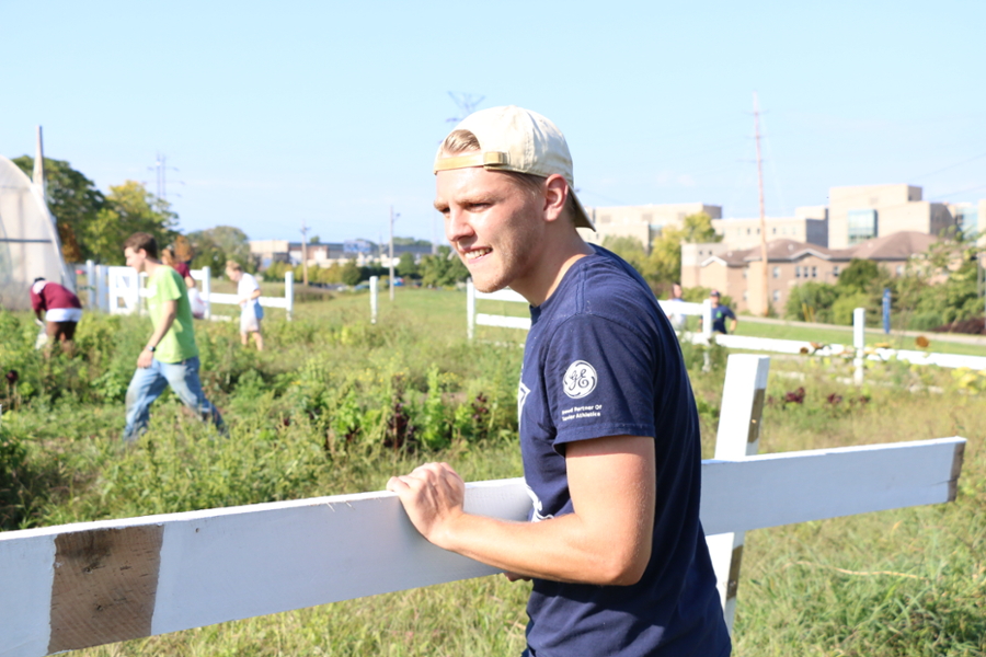 Xavier student working in a garden