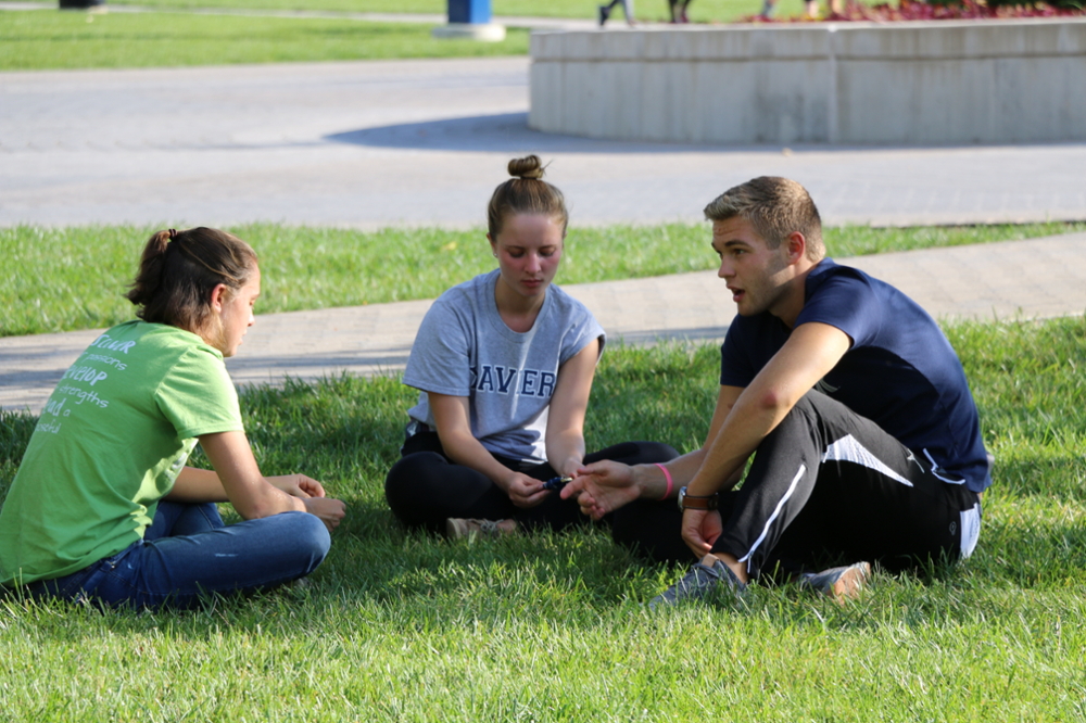 Xavier students sitting on the yard